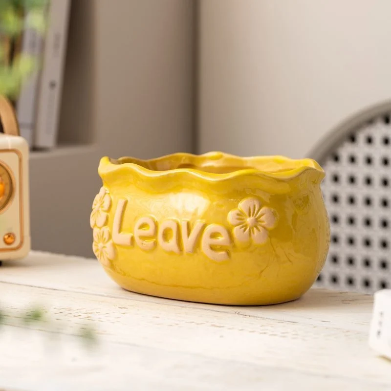 Yellow oval ceramic planter with flowers and Leave quote