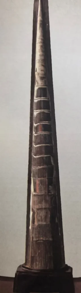Tall, conical Sinoceras fossil mounted on a base