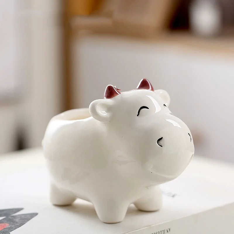 Smiling ceramic cow planter for home and office decor