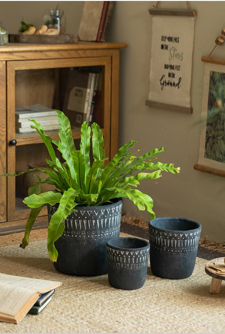Large dark gray concrete planter with a fern plant