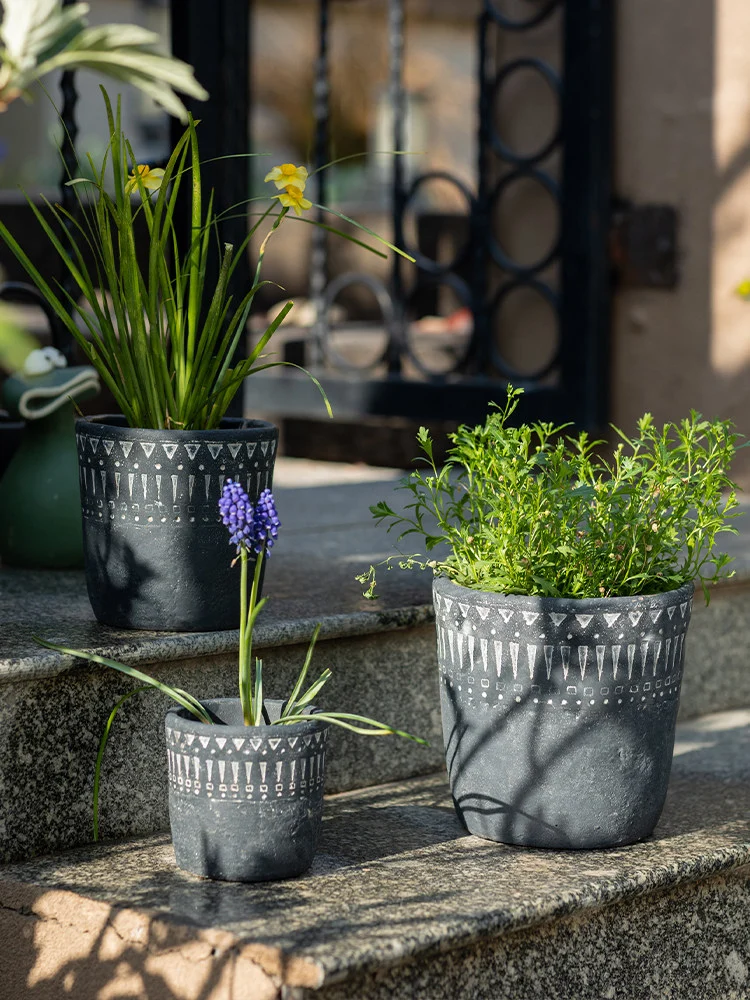Dark gray concrete planters on stone steps