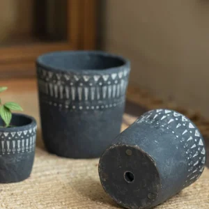 Vintage dark gray concrete planter with white geometric patterns